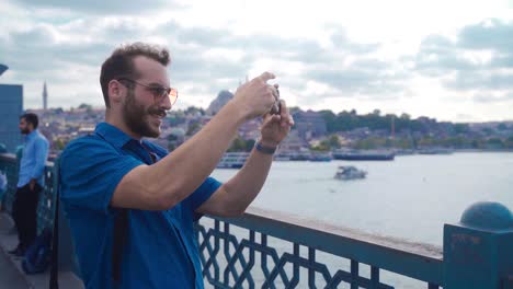 In-Istanbul,-the-young-man-takes-a-picture-with-his-phone.